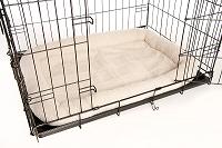 Bolster dog bed in metal crate carrier